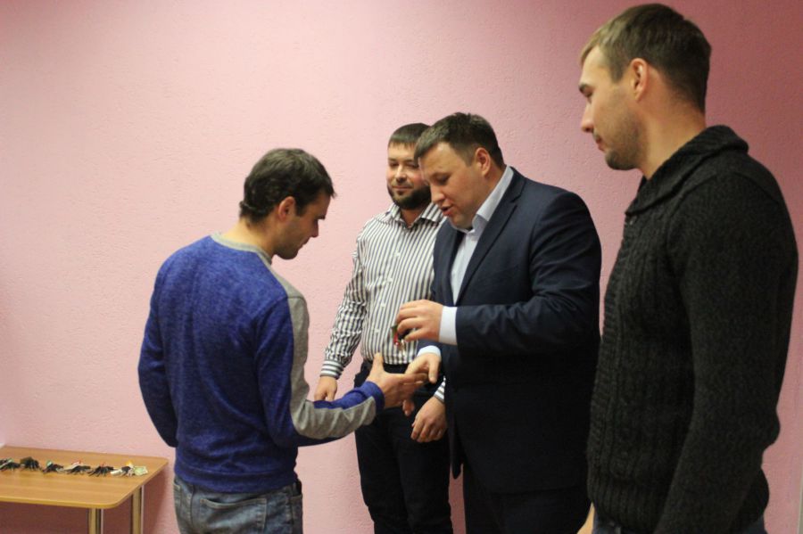 Счастливых новосёлов поздравляют А. Вервейн,  А. Шипулин и И. Бидонько.
